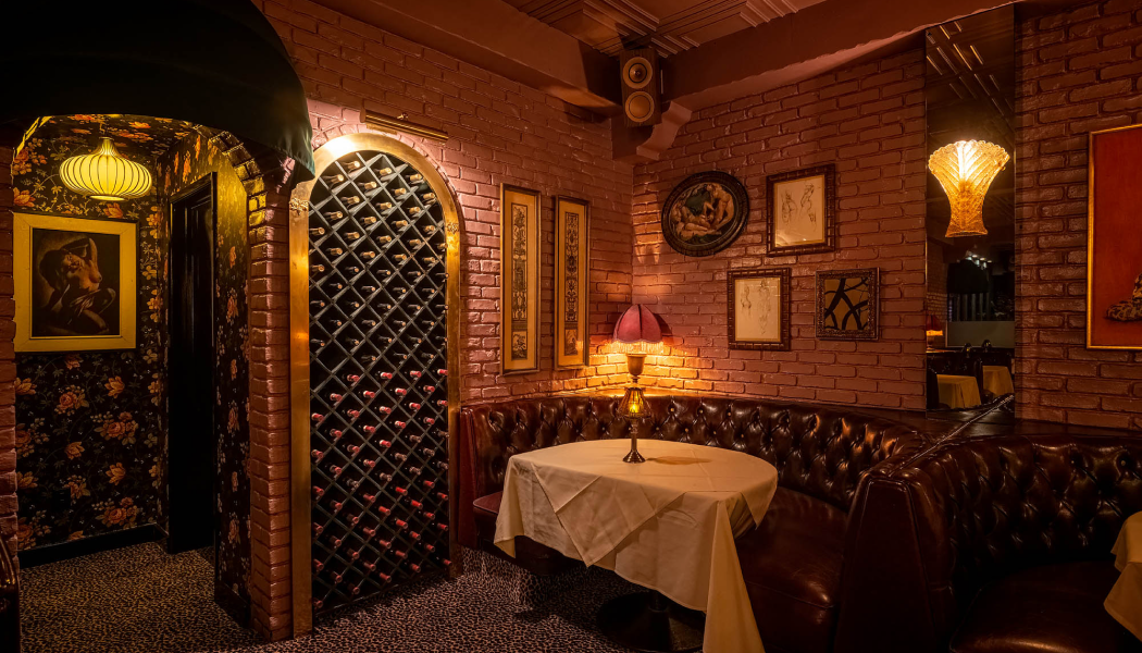 La dolce vita in Beverly hills dinner table alongside wine rack and vintage leather concept setup